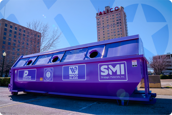 Large purple glass recycling bin in front of the ALICO building in Downtown Waco.
