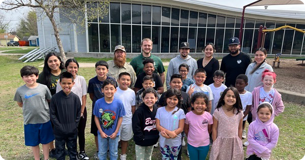 A group of kids standing with Parks & Recreation staff in front during spring break camp.