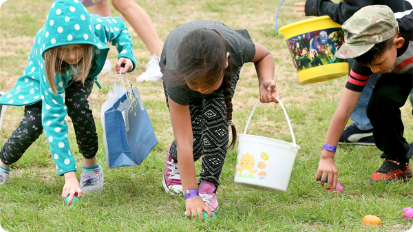Kids picking up Easter eggs.