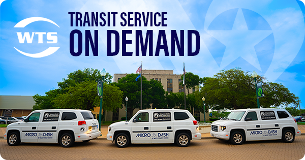 Three white vans parked in front of Waco City Hall.