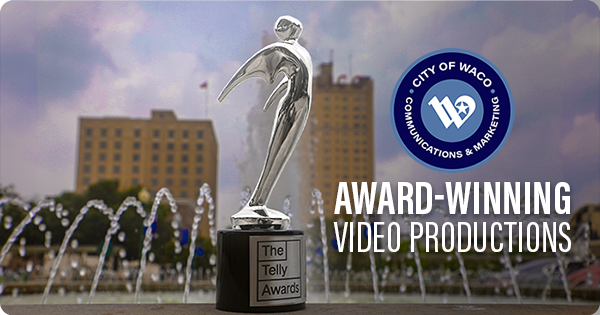 Telly Award trophy on a fountain with Downtown Waco in the background.