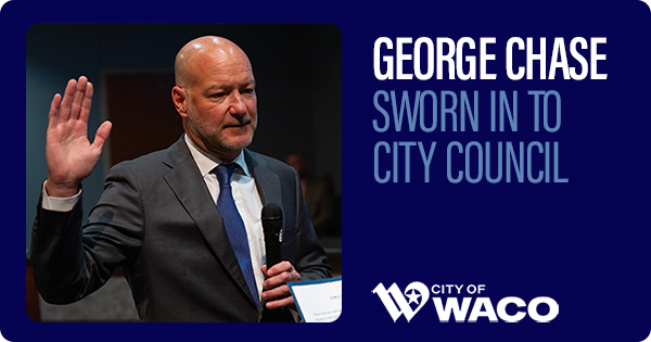 George Chase holding right hand up getting sworn in to City Council