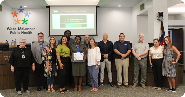 Health District representatives receive award from Waco ISD staff and board members.