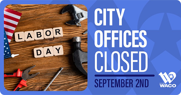 Tiles on a wood surface that read Labor Day surrounded by tools and an American flag.