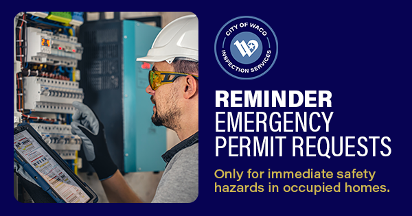 A man in a hard hat interacting with an electrical box