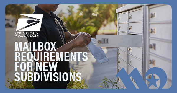A black man taking his mail out of a cluster mailbox in his neighborhood.