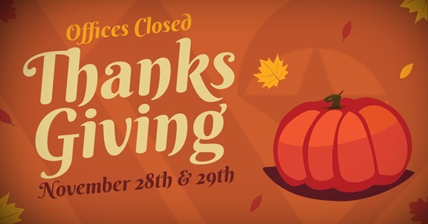 An orange pumpkin and floating fall leaves