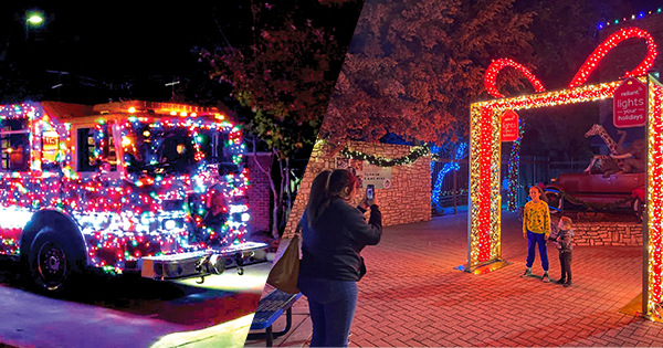 A fire engine decorated in Christmas lights and a mom taking a picture of her kids under a light display.