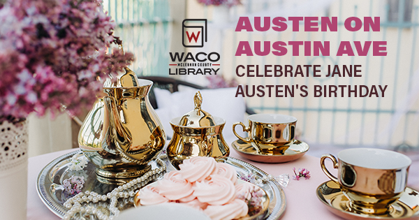 A table set for tea time with a gold tea set, pink flowers, and pink sweets.