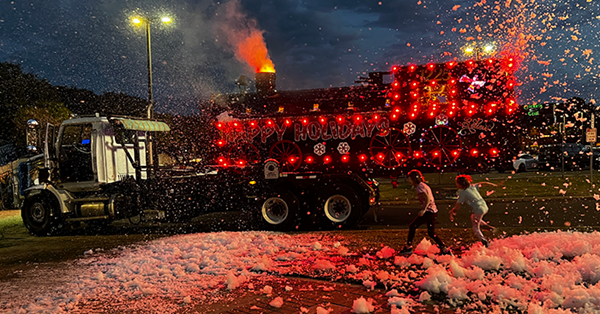 Solid Waste truck decorated as the Polar Express with lights and a bubble machine