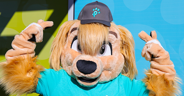 A dog mascot showing off a new Pet Circle Waco t-shirt and cap