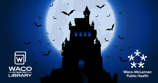 Silhouette of Dracula's Castle on a tall hill with the moon in the background 
