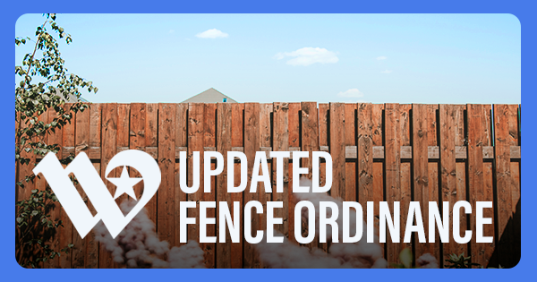 A residential wooden fence in a backyard