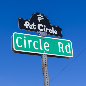 Pet Circle sign topper over Circle Road Street Sign