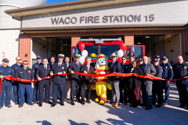 City officials, firefighters, and Sparky the Fire Dog at the Fire Station 15 ribbon cutting