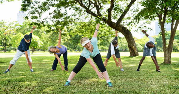 Five people exercising outside