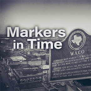 Black and white photo of a historical marker and downtown Waco