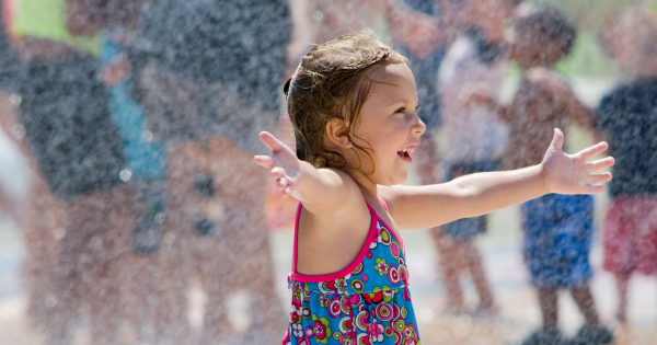 A little girl playing in a splash pad