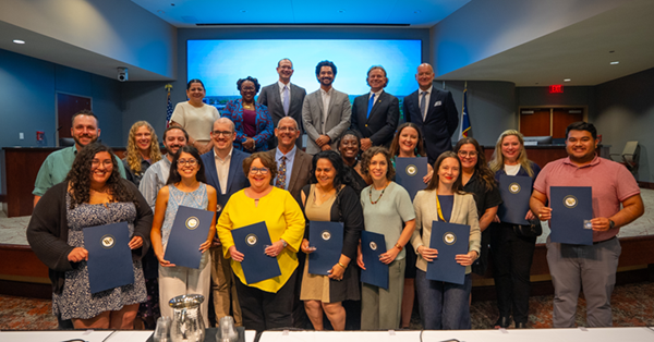 Waco City Academy graduates holding their certificates with City Council