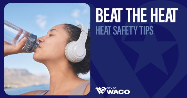 A woman wearing headphones drinking water