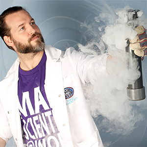 A man in a lab coat holding a smoking cylinder