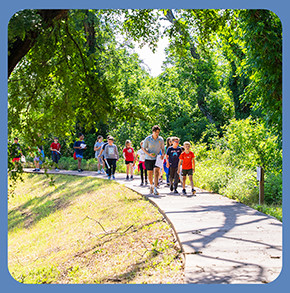 An elementary school class walking up a path at Lake Waco Wetlands