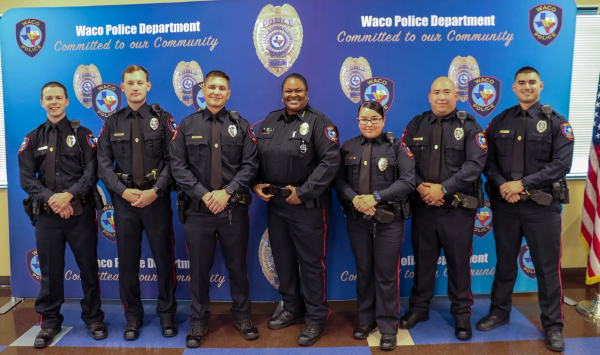Six police officers, five men and one woman, standing with Police Chief Sheryl Victorian
