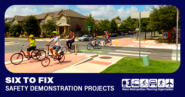 A group of people riding their bikes down the street