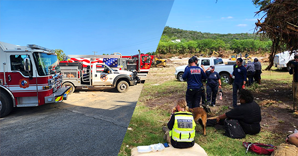 First responders gathered in a field with damaged trees, debris, and heavy machinery in the background.