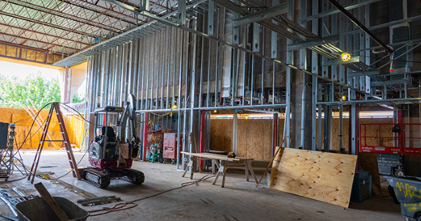 Interior of building under construction with metal stud framing.