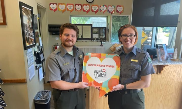 Mammoth National Monument staff holding the Locals Love Us Award