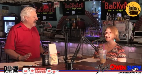 Two people talking into microphones for live show