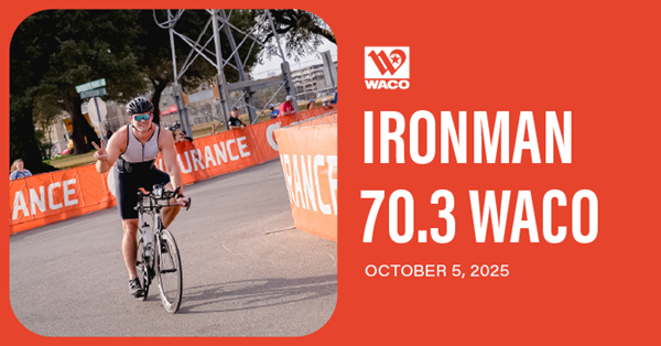 An athlete riding a bicycle on the Ironman course