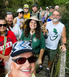 Group of people taking a selfie with a park ranger in Cameron Park
