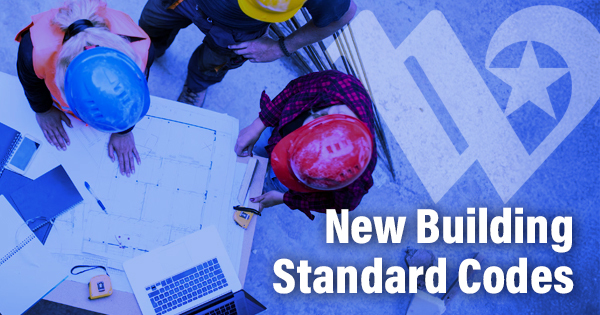 Birds-eye view of construction workers looking at construction plans