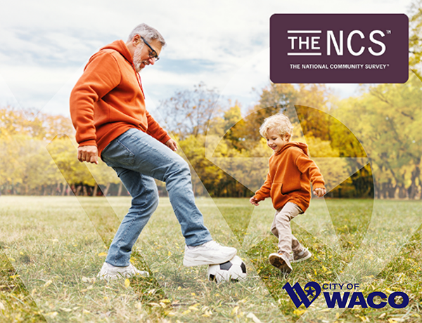 man and child playing with a soccer ball