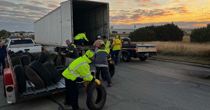 Men loading tires into a truck