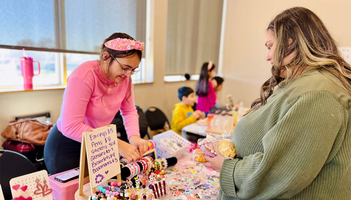 A girl selling handmade jewelry