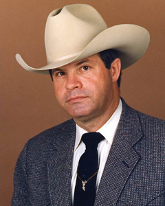 photo of Stewart in white cowboy hat and suit