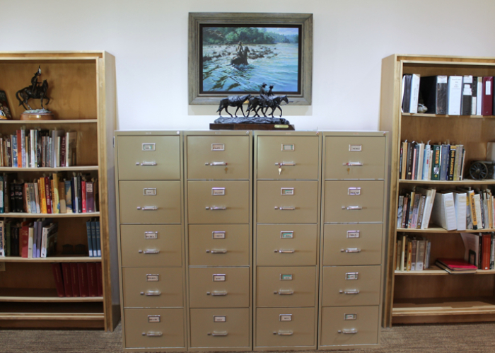 four tall filing cabinets between bookshelves