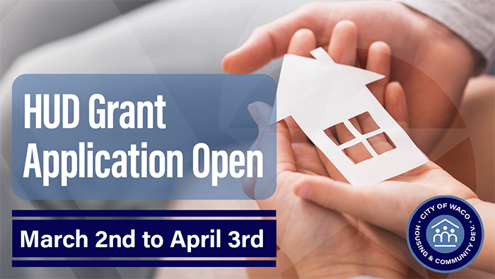 Close up of a man's and child's hands holding a paper cut out of a house