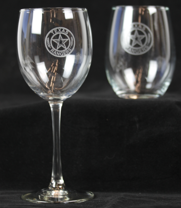 two clear wineglasses on black background