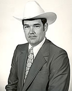black and white photo of man in suit and white hat