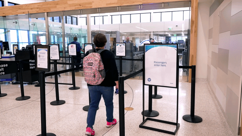 Three people walking up to an empty TSA line at the Waco Airport