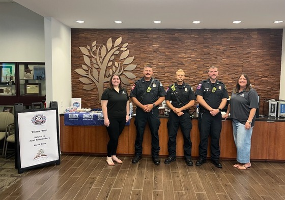 Members of the Neighborhood Services teampost with Montgomery County police at Town Hall 