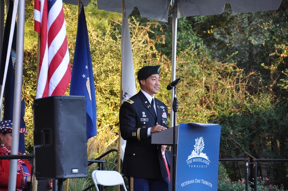 An army officer in full uniform delivers a speech from behind the Township podium on Veterans Day. 