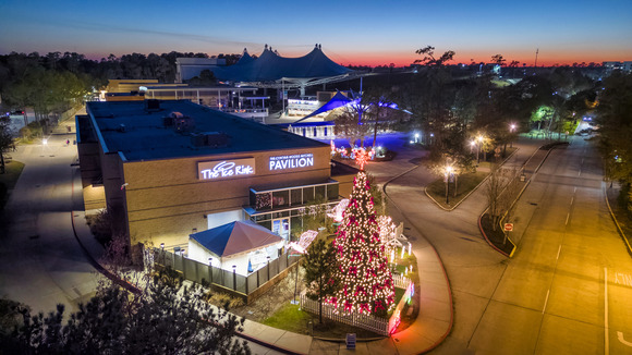 an aerial image of The Ice Rink exterior at night, with a Christmas tree in the foreground