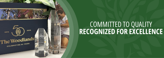 Committed to Quality, Recognized for Excellence; Photo of a blue book and two crystal awards