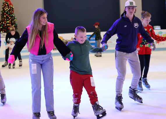 Image of three people ice skating