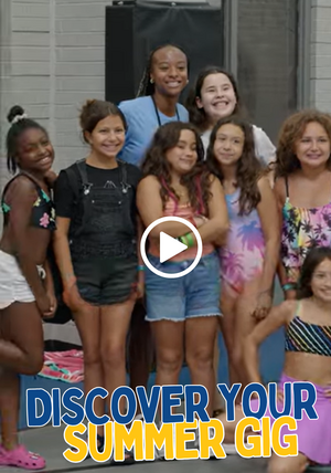 A young camp counselor with smiling children